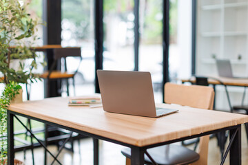 Laotop Empty workspace, no people, office desk, with laptop, calculator, graphs, documents on the table.
