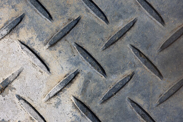 Weathered metal diamond plate close-up abstract background texture