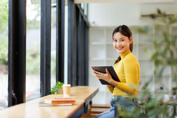 Young business asian woman manage business freelancer using Tablet laptop at the office.	
