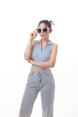 Fototapeta premium Stylish Young Woman Posing Confidently with Sunglasses in Minimalist Studio Setting with White Background