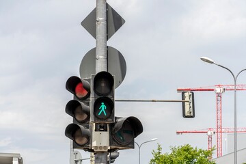 Pedestrian green and vehicle red traffic lights under sunny conditions