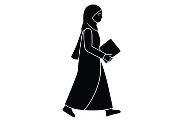 Young woman in hijab walking and holding a quran