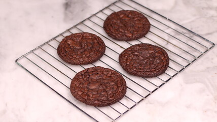 Fudgy Brownie Cookies combine the rich, chewy center of a brownie with the crisp edges of a cookie. With glossy, crackly tops and deep chocolate flavor, these cookies offer melt-in-your-mouth indulgen