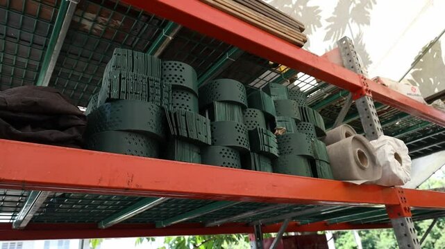 Low angle shot of synthetic Bohio materials stored on metal shelves include green plastic pieces