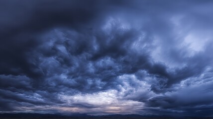 Obraz premium Dramatic storm clouds in deep blue, a sweeping skyscape with dynamic light, nature's raw power on display