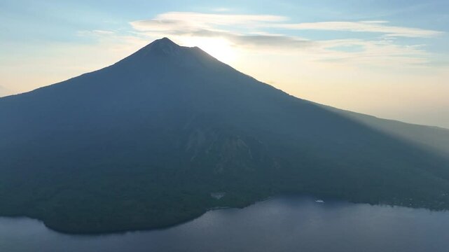 Sunset illuminates the peak of Iliape volcano on Lembata Island in the Lesser Sunda Islands of Indonesia. This scenic volcano in the ring of fire has been extremely active since 2024.