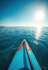 Vibrant kayak glides on calm blue waters under bright sun, evoking sense of adventure and serenity