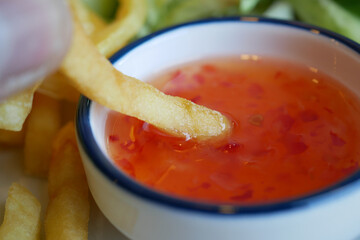 Fries and sweet chili sauce in a casual vibe