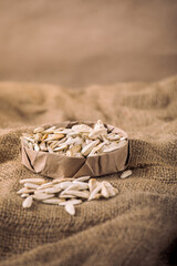 Colorful Candy-White Sunflower Seeds in Paper Bowl on Burlap Fabric – Rustic Healthy SnackCoated Chickpeas – Fun and Sweet Snack
