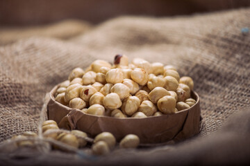 Hazelnuts and Almonds in Paper Containers on White Background – Isolated Nuts