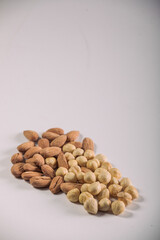 Hazelnuts and Almonds in Paper Containers on White Background – Isolated Nuts