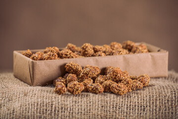 Marinated Nuts with Brown Sauce and Sesame on White Background– Rustic Gourmet Snack