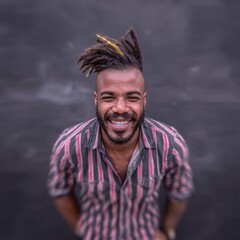 Portrait of a smiling man with dreadlocks