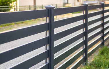 Modern stone fence with aluminum or metal shutter
