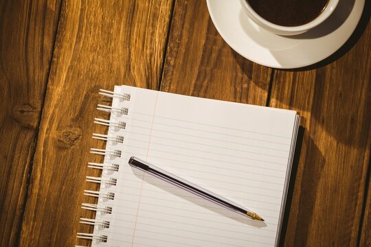 Desk with coffee and notepad - Powered by Adobe