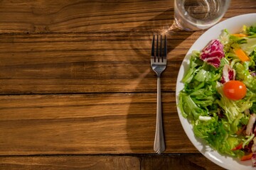Healthy bowl of salad on wooden table