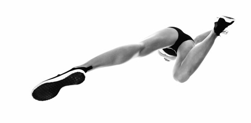 Low angle view of sportswoman long jumping
