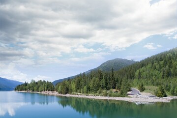 Trees reflecting in calm lake against sky