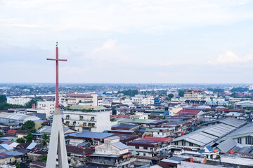 Skyline of Pontianak city reflecting its ethnic and religious diversity, marked by a church steeple...
