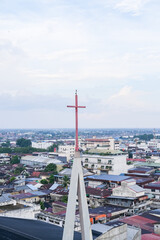 Skyline of Pontianak city reflecting its ethnic and religious diversity, marked by a church steeple...