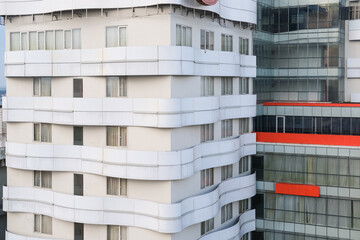 Modern high-rise buildings with clean white façades and layered architectural features, showcasing...