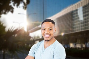 Portrait of smiling man against modern building in city