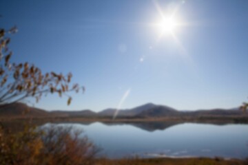 Lake against blue clear sky
