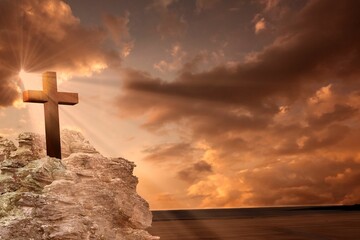 Cross religion symbol shape over sunset sky