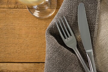 Fork and knife on sack at wooden table © vectorfusionart