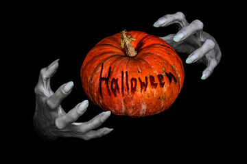 Bony pale monsters hands with sharp nails and pumpkin with lettering Halloween between them, isolated on black.