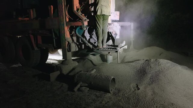 Borewell Rig Illuminated Under Night Sky