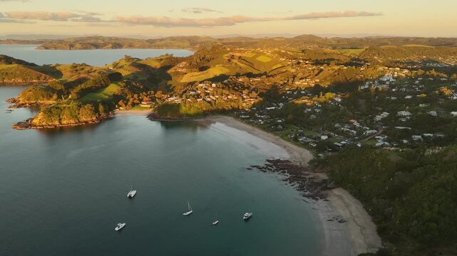 Breathtaking 4K panoramic views of Palm Beach on Waiheke Island, New Zealand, at sunset. Experience the serene beauty of the Hauraki Gulf.