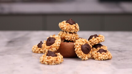 Cheese Peanut Chocolate in the photo on a marble table and small wooden bowl and mesh pan