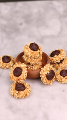 Cheese Peanut Chocolate in the photo on a marble table and small wooden bowl and mesh pan