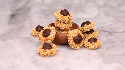 Cheese Peanut Chocolate in the photo on a marble table and small wooden bowl and mesh pan
