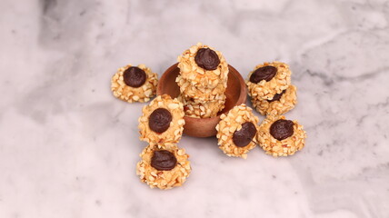 Cheese Peanut Chocolate in the photo on a marble table and small wooden bowl and mesh pan