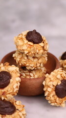 Cheese Peanut Chocolate in the photo on a marble table and small wooden bowl and mesh pan