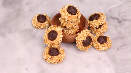 Cheese Peanut Chocolate in the photo on a marble table and small wooden bowl and mesh pan