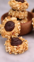 Cheese Peanut Chocolate in the photo on a marble table and small wooden bowl and mesh pan