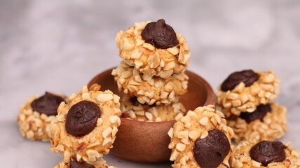 Cheese Peanut Chocolate in the photo on a marble table and small wooden bowl and mesh pan
