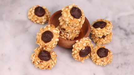 Cheese Peanut Chocolate in the photo on a marble table and small wooden bowl and mesh pan