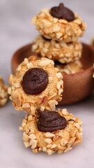 Cheese Peanut Chocolate in the photo on a marble table and small wooden bowl and mesh pan