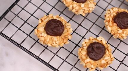 Cheese Peanut Chocolate in the photo on a marble table and small wooden bowl and mesh pan