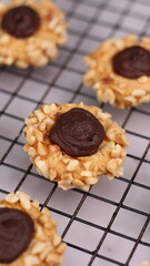 Cheese Peanut Chocolate in the photo on a marble table and small wooden bowl and mesh pan
