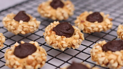Cheese Peanut Chocolate in the photo on a marble table and small wooden bowl and mesh pan
