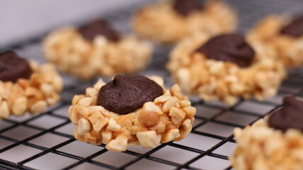 Cheese Peanut Chocolate in the photo on a marble table and small wooden bowl and mesh pan