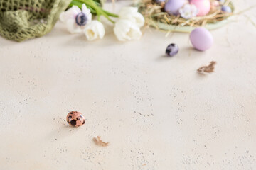 Easter eggs with pink tulips, rustic bright overhead composition with minimal copyspace