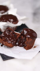 chocolate cake wrapped in cake paper with chocolate glaze topping