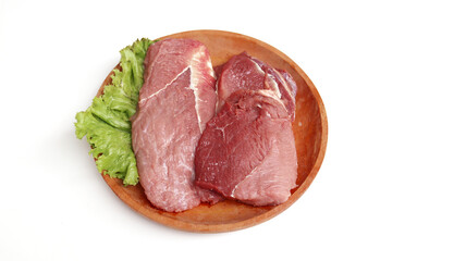 Fresh raw meet on wooden plate isolated on white background