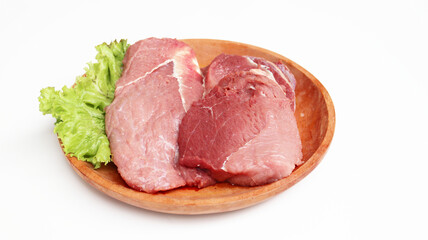 Fresh raw meet on wooden plate isolated on white background